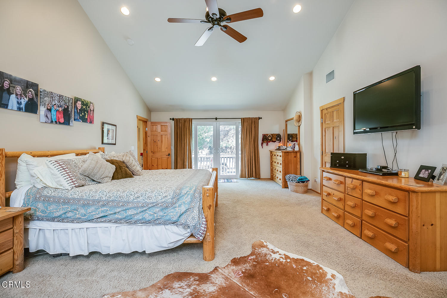 9972 Creek Road Oak View, CA 93022 - Photo 27 of 50 a bedroom with a large bed and a flat screen television