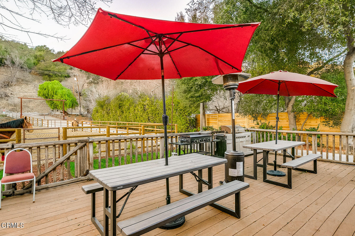 9972 Creek Road Oak View, CA 93022 - Photo 39 of 50 a view of a balcony with chairs and wooden umbrella