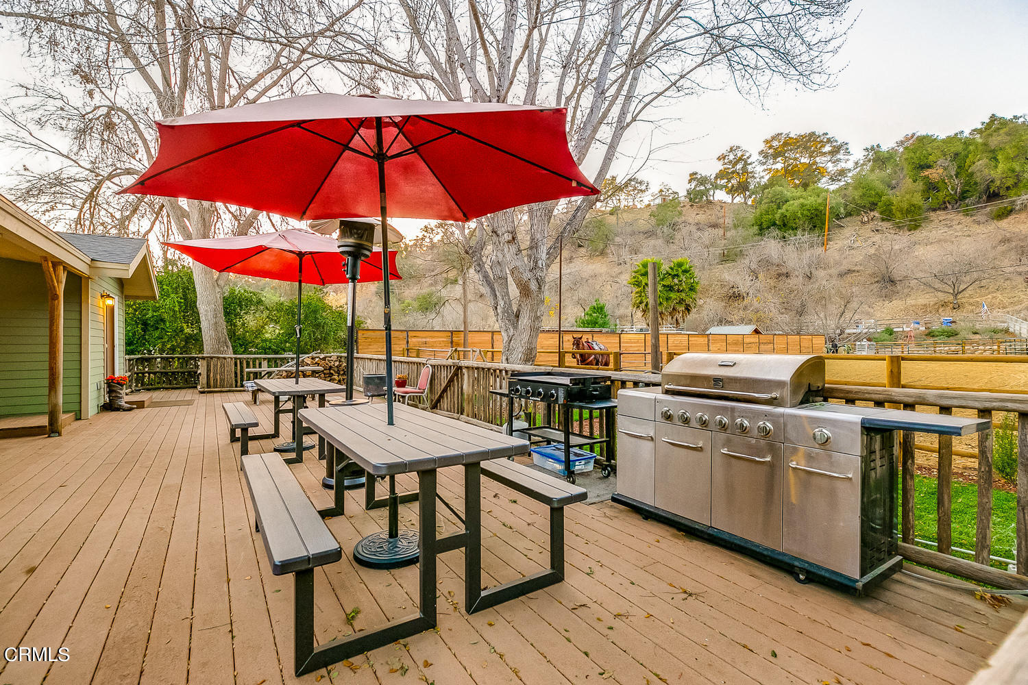 9972 Creek Road Oak View, CA 93022 - Photo 40 of 50 a view of a patio with chairs and table under an umbrella