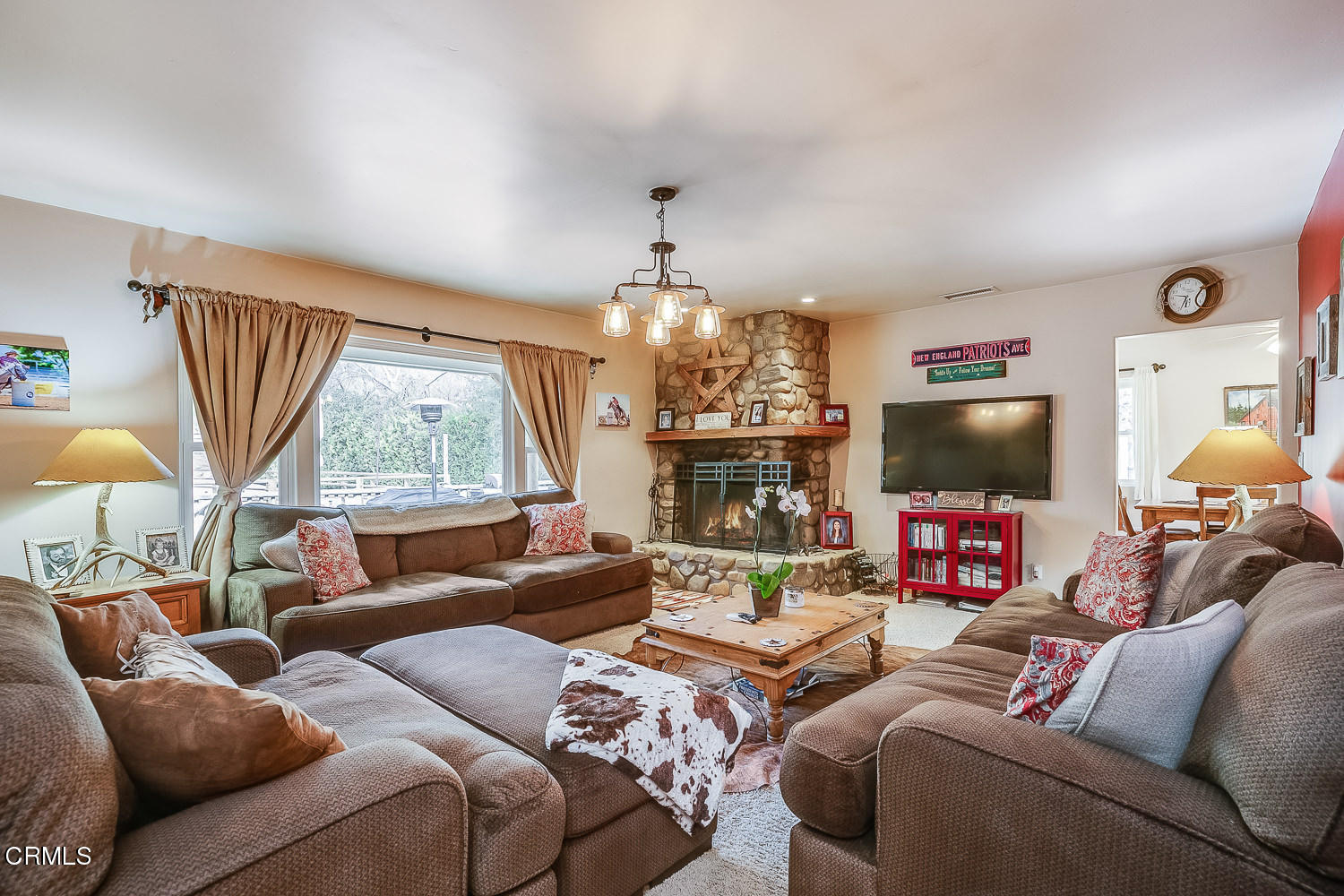 9972 Creek Road Oak View, CA 93022 - Photo 10 of 50 a living room with furniture a flat screen tv and a large window