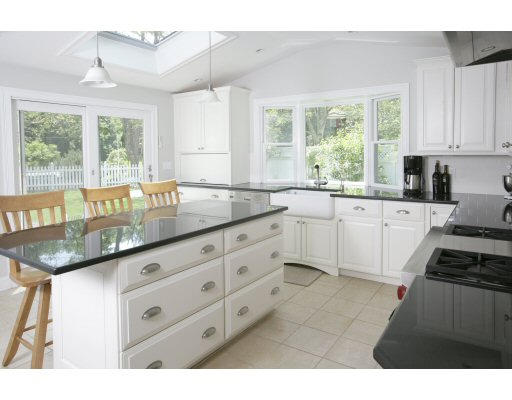 15 Pheasant Road Newton, MA 02460 - Photo 2 of 7 a kitchen with granite countertop a sink white cabinets and a window