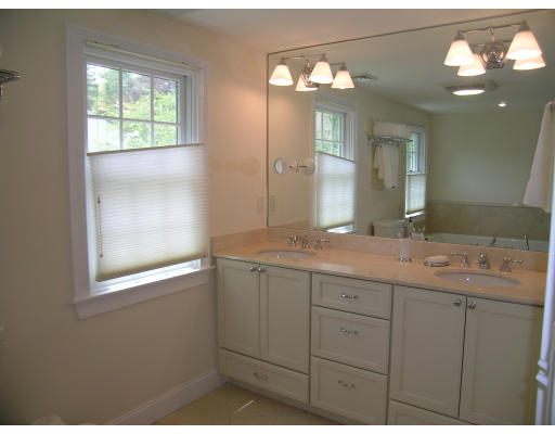15 Pheasant Road Newton, MA 02460 - Photo 6 of 7 a bathroom with a granite countertop sink a large mirror a vanity and a window