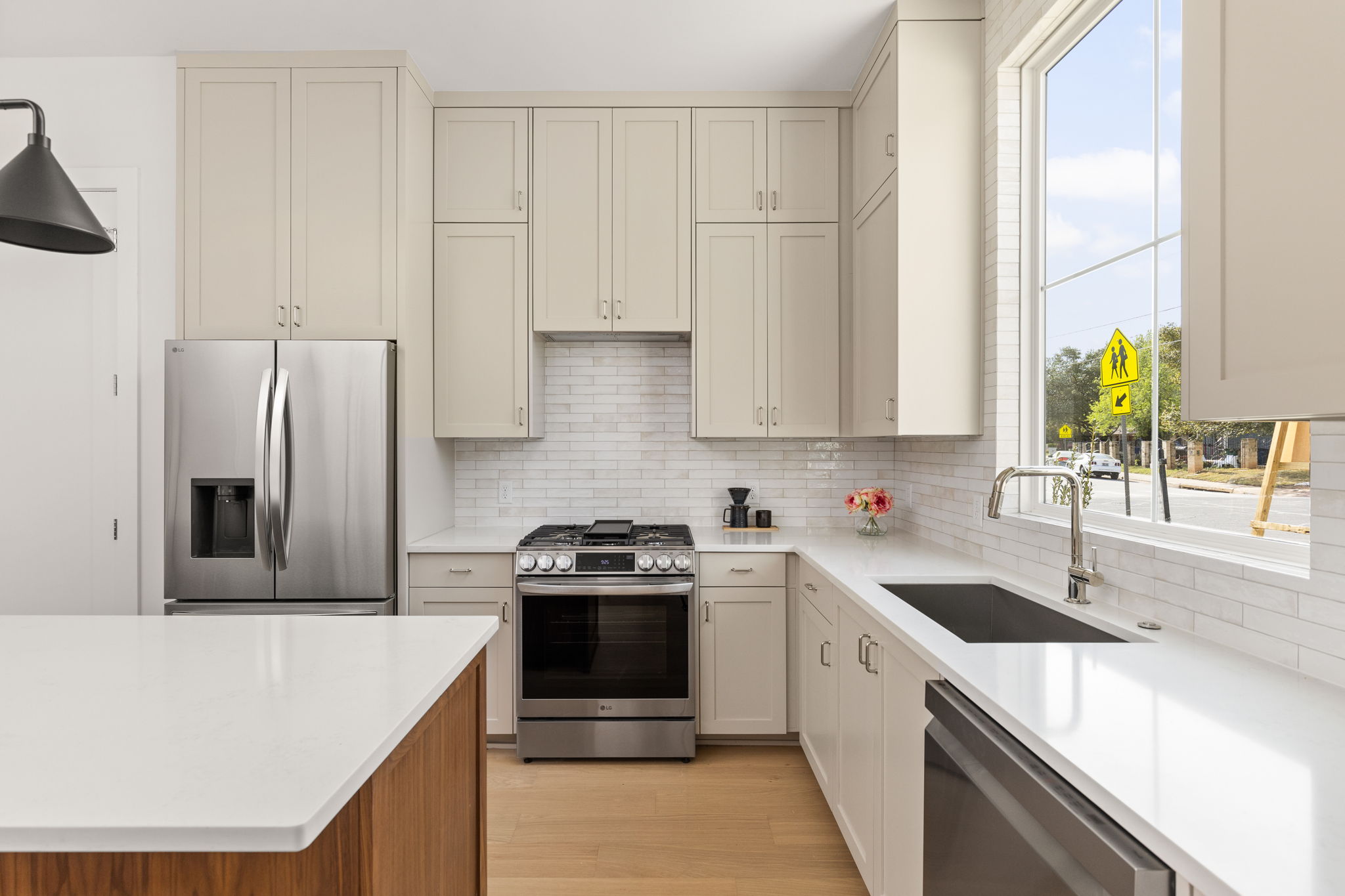 2910 East 4th Street Austin, TX 78702 - Photo 9 of 39 a kitchen with stainless steel appliances granite countertop a sink stove and refrigerator