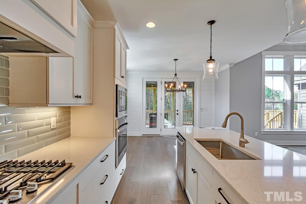 6409 Camellia Creek Drive Raleigh, NC 27603 - Photo 11 of 30 a kitchen with granite countertop a sink stainless steel appliances and cabinets
