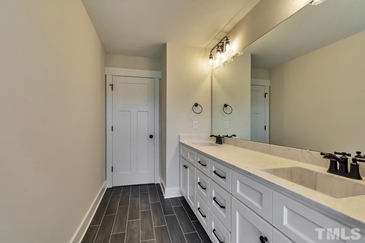6409 Camellia Creek Drive Raleigh, NC 27603 - Photo 15 of 30 a bathroom with a sink and a mirror