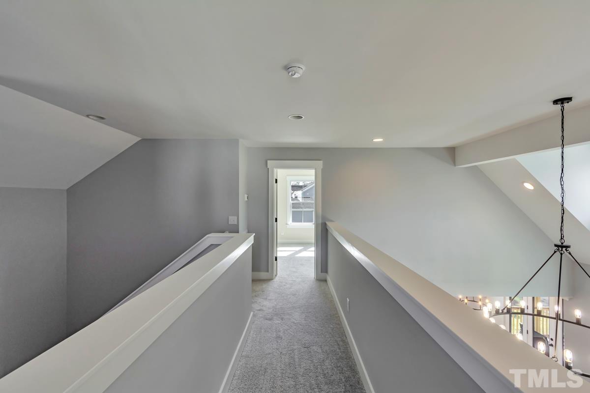 6409 Camellia Creek Drive Raleigh, NC 27603 - Photo 16 of 30 a hallway with white cabinets and wooden floor