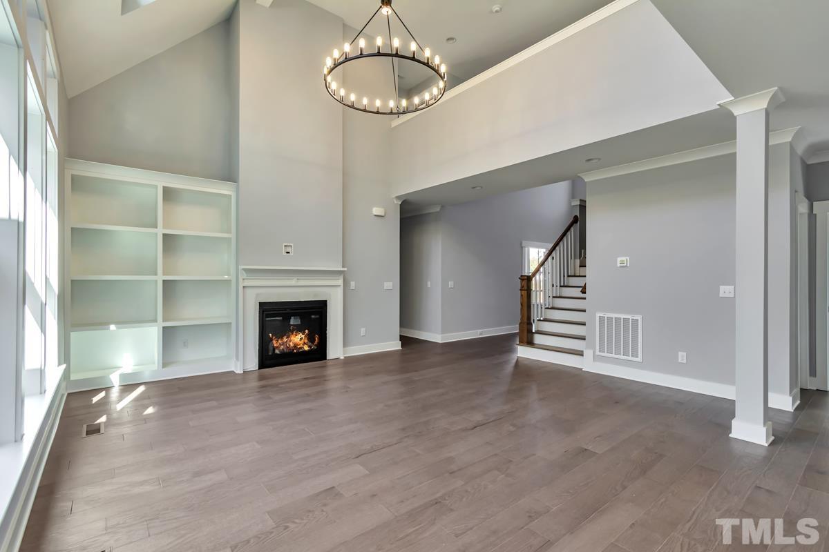 6409 Camellia Creek Drive Raleigh, NC 27603 - Photo 19 of 30 a view of empty room with wooden floor and fireplace