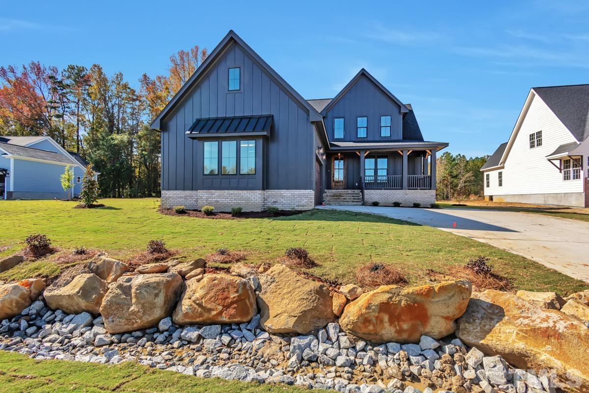 6409 Camellia Creek Drive Raleigh, NC 27603 - Photo 2 of 30 a front view of a house with swimming pool and porch