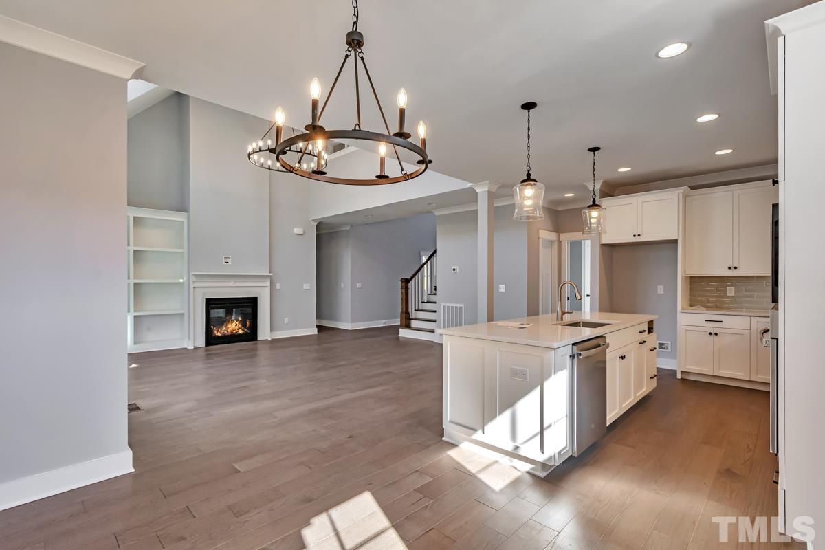 6409 Camellia Creek Drive Raleigh, NC 27603 - Photo 21 of 30 a large kitchen with a lot of counter space and a fireplace