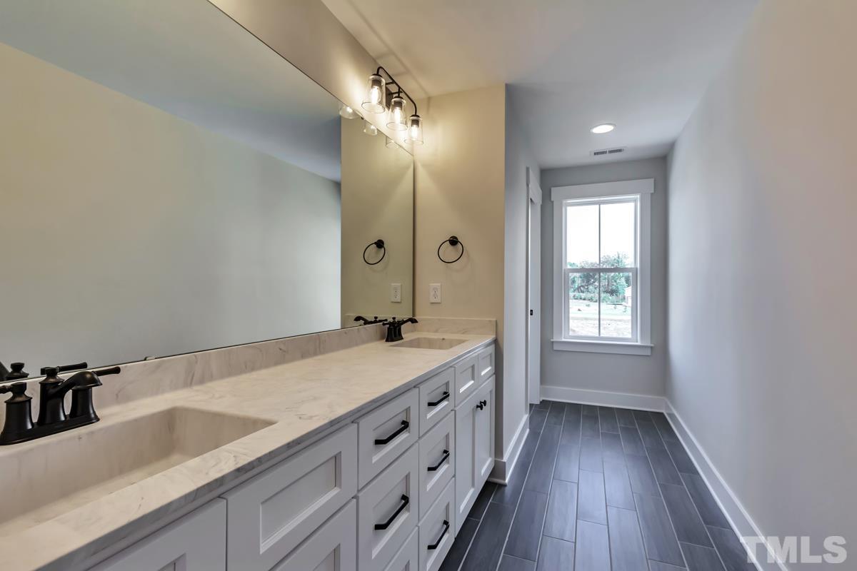 6409 Camellia Creek Drive Raleigh, NC 27603 - Photo 23 of 30 a bathroom with a sink and a mirror