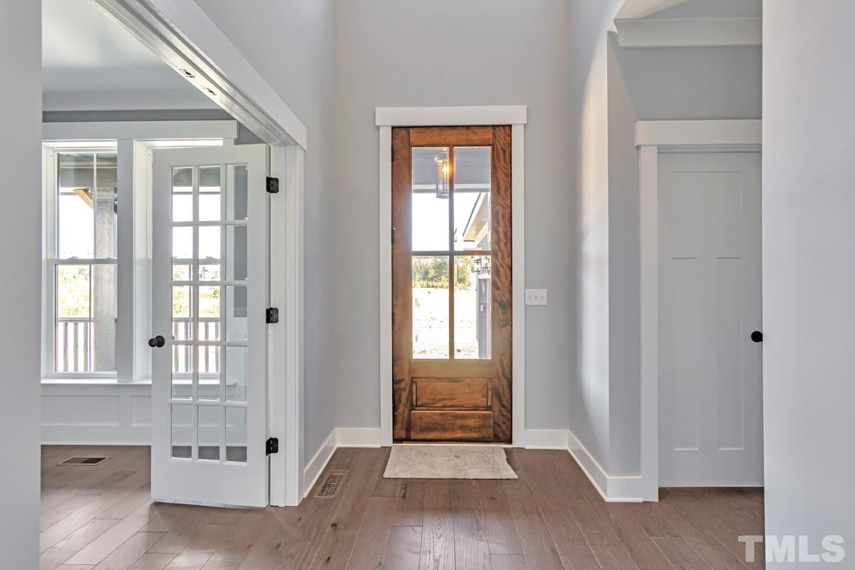 6409 Camellia Creek Drive Raleigh, NC 27603 - Photo 28 of 30 a view of an entryway with wooden floor and door
