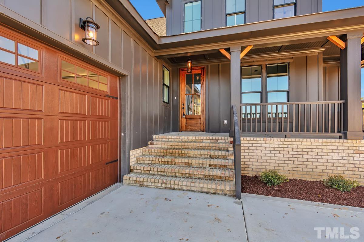 6409 Camellia Creek Drive Raleigh, NC 27603 - Photo 3 of 30 a view of a house with a door and wooden bench