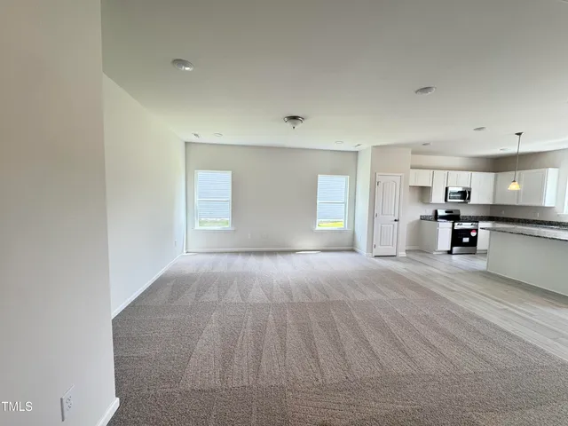 a view of kitchen with sink and window