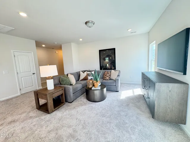 a kitchen with stainless steel appliances granite countertop a sink dishwasher a stove a refrigerator and a dining table with wooden floor