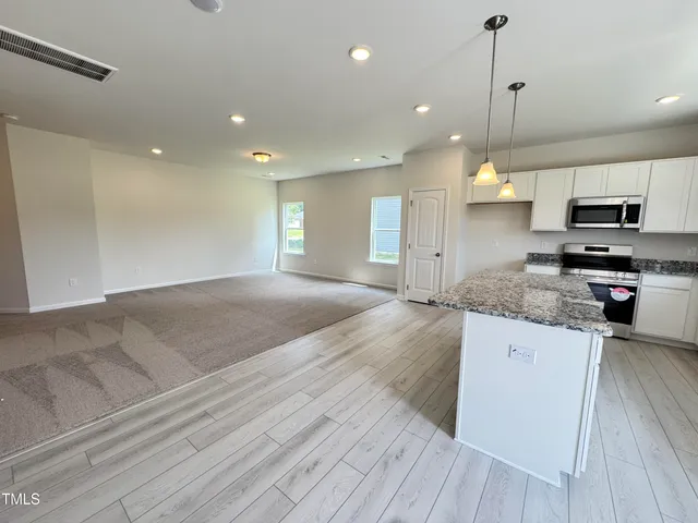 a kitchen with a sink cabinets and window