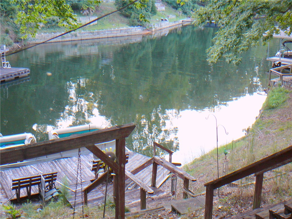 88 Catfish Cove Road Abbeville, SC 29620 - Photo 3 of 5 Stairs descend to a private wooden dock overlooking calm waters and lush tree-lined shores.