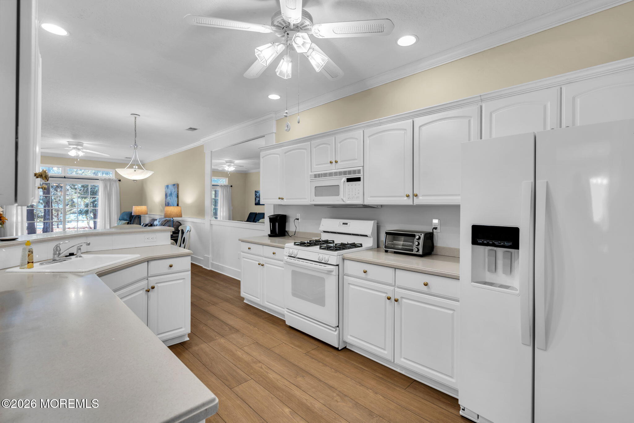 104 Silverlawns Drive Lakewood, NJ 08701 - Photo 17 of 36 a large white kitchen with stainless steel appliances granite countertop a stove a sink a refrigerator and white cabinets with wooden floor
