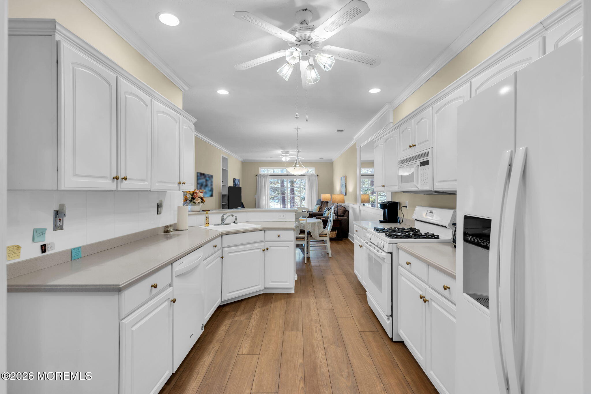 104 Silverlawns Drive Lakewood, NJ 08701 - Photo 18 of 36 a kitchen with white cabinets appliances and a chandelier