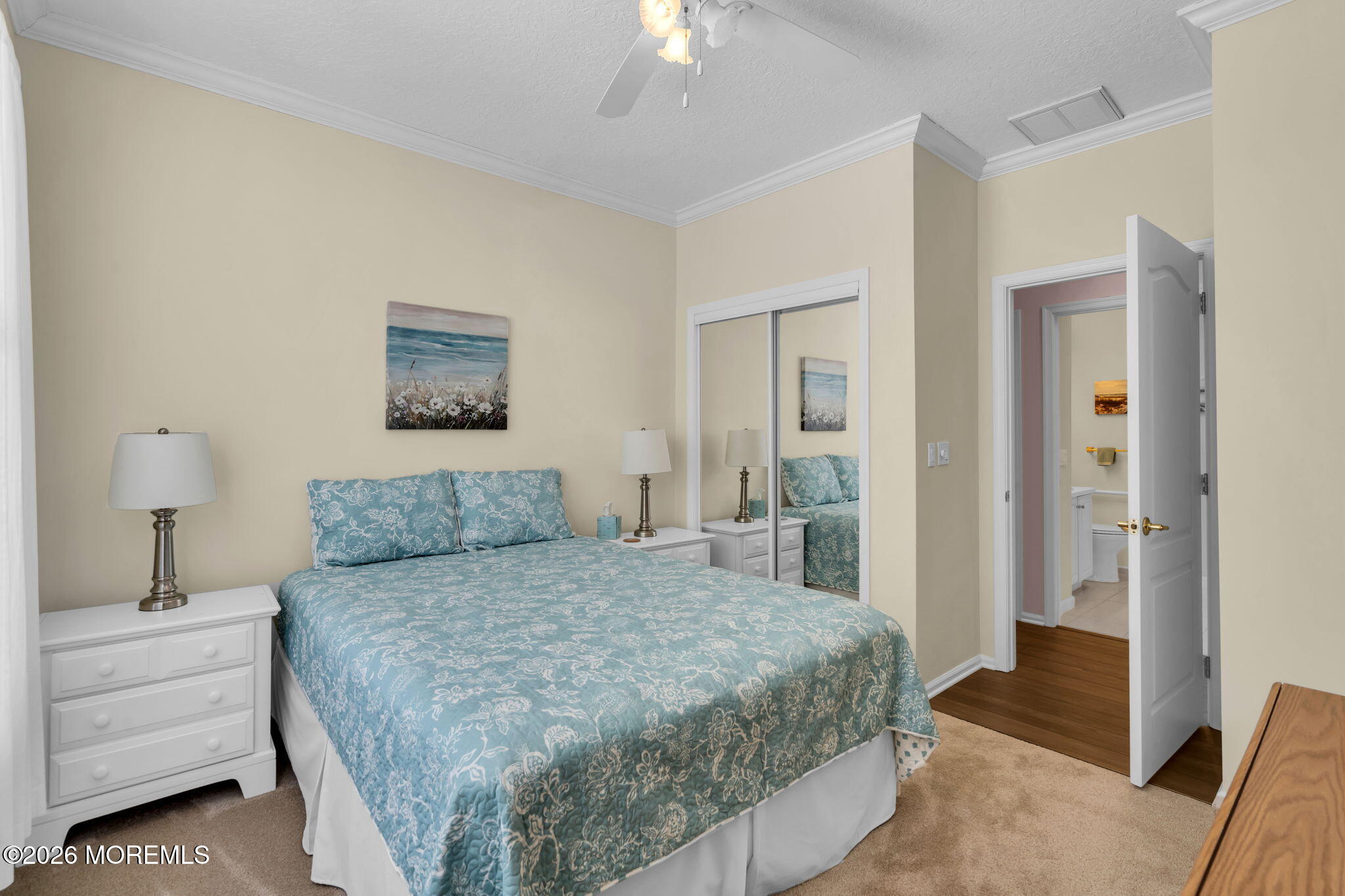 104 Silverlawns Drive Lakewood, NJ 08701 - Photo 23 of 36 a bedroom with a bed and a chandelier