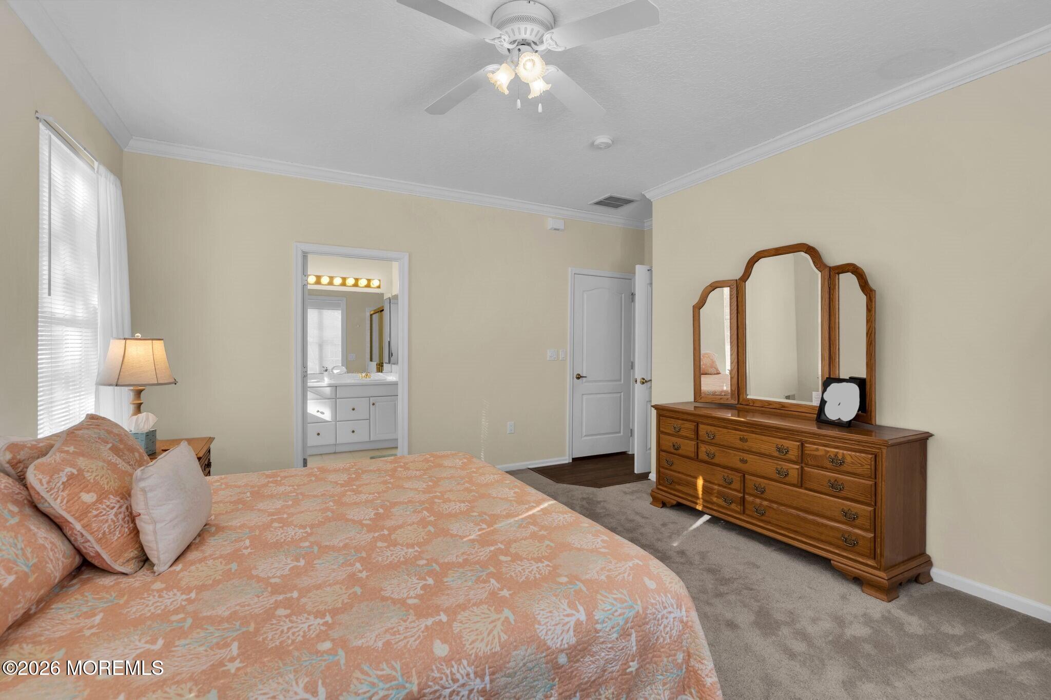 104 Silverlawns Drive Lakewood, NJ 08701 - Photo 26 of 36 a bedroom with a bed and dresser with mirror