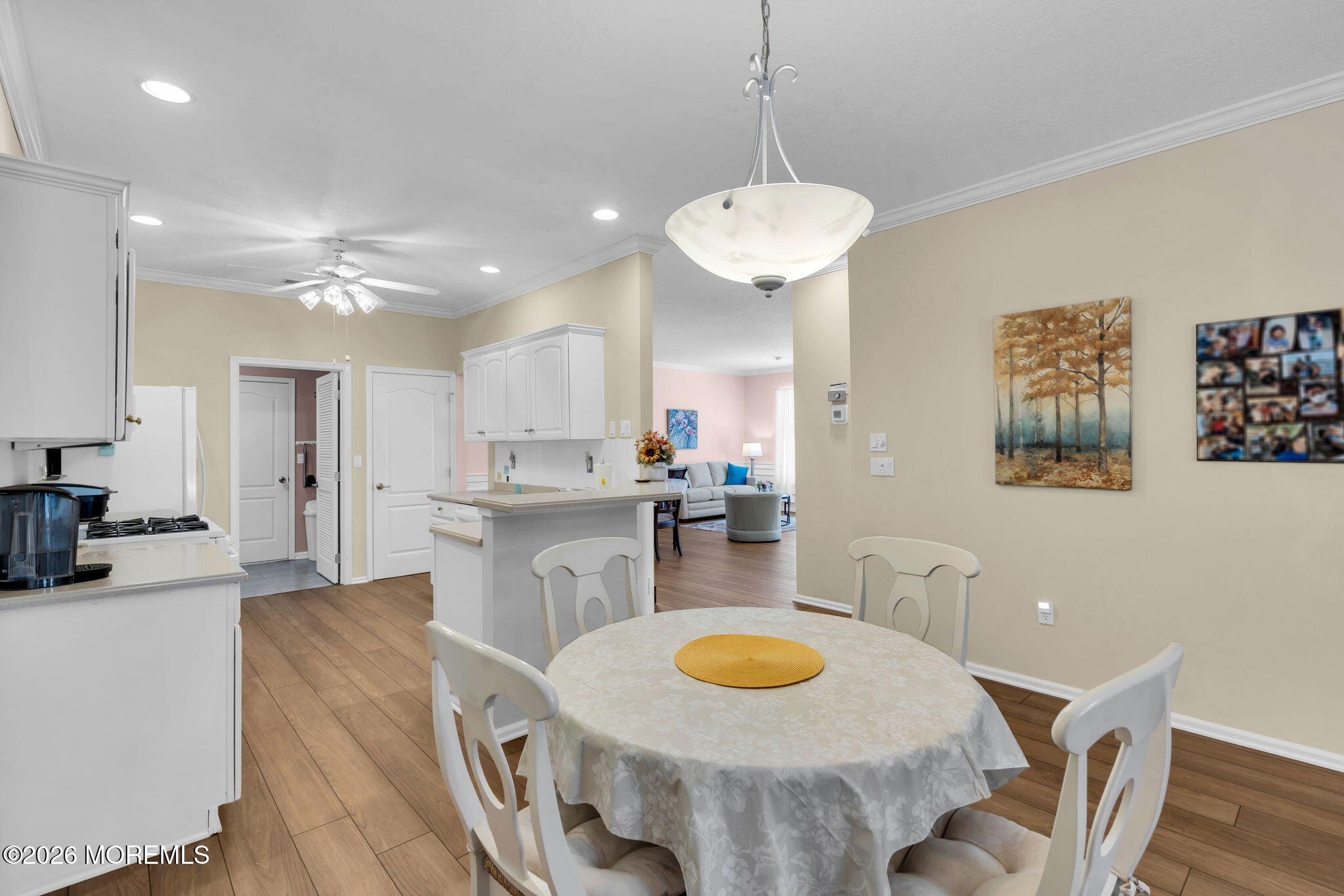 104 Silverlawns Drive Lakewood, NJ 08701 - Photo 9 of 36 a view of a dining room and livingroom with furniture wooden floor a chandelier