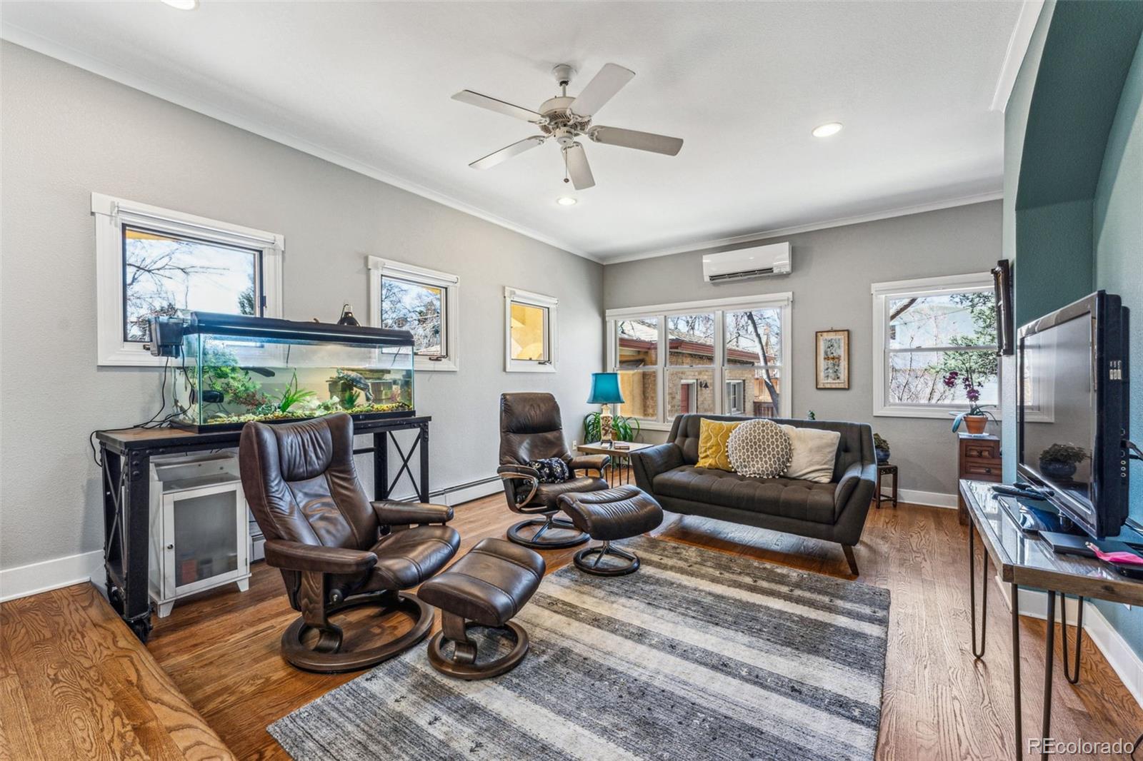 1965 Jasmine Street Denver, CO 80220 - Photo 19 of 41 a living room with furniture a rug and a flat screen tv