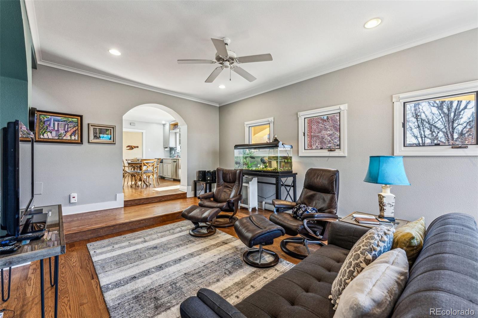 1965 Jasmine Street Denver, CO 80220 - Photo 20 of 41 a living room with furniture a fireplace and a flat screen tv