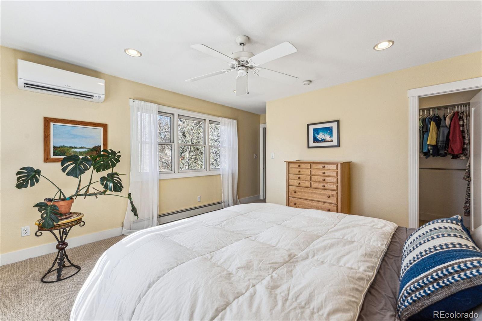 1965 Jasmine Street Denver, CO 80220 - Photo 22 of 41 a bedroom with a bed and a chandelier