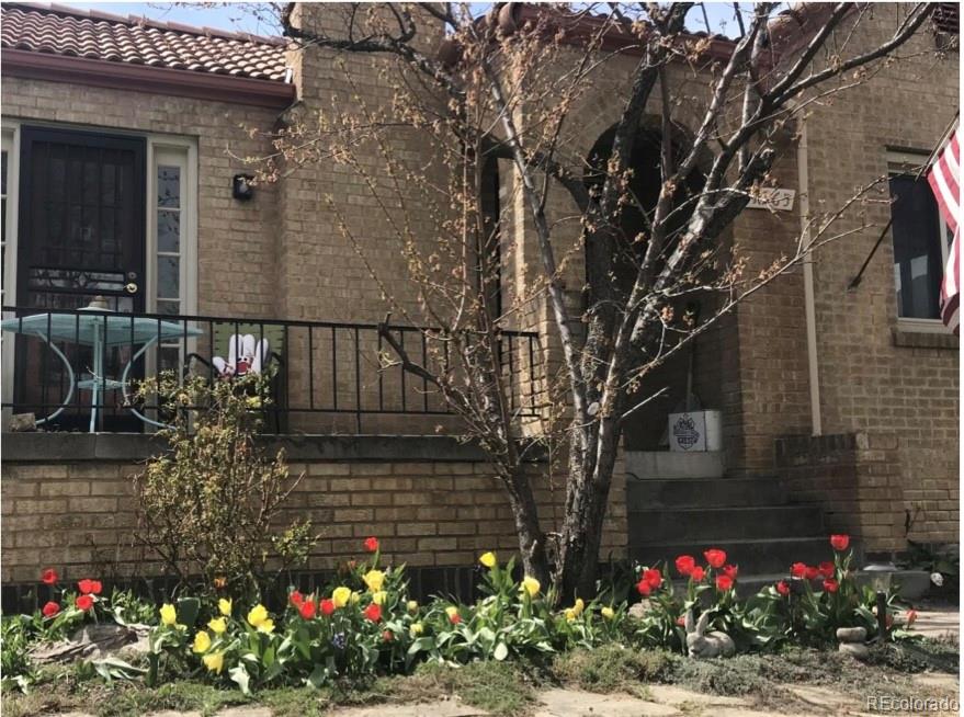 1965 Jasmine Street Denver, CO 80220 - Photo 34 of 41 a front view of a house with flowers