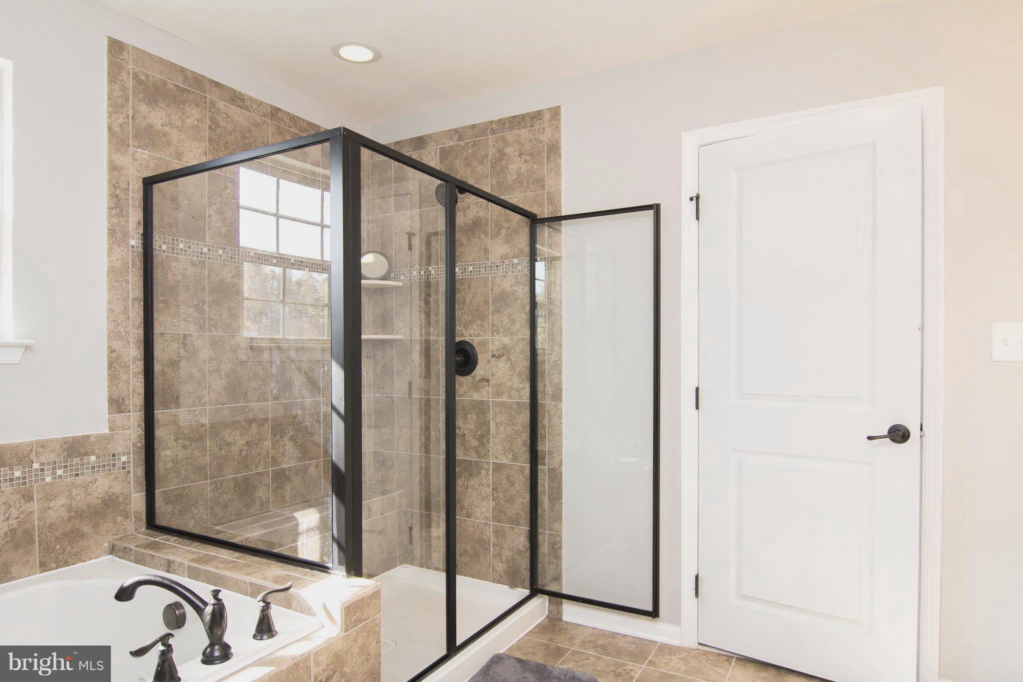 10422 Windlass Run Road Baltimore, MD 21220 - Photo 18 of 30 a bathroom with a bathtub and a shower