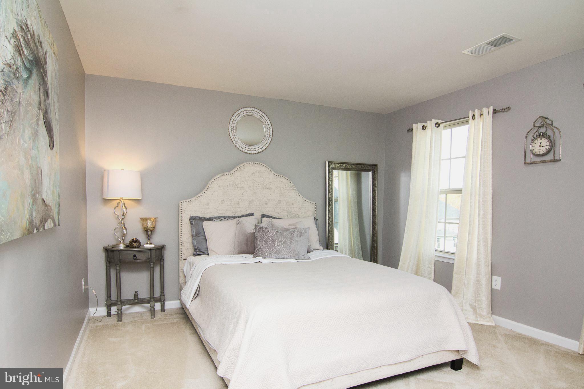 10422 Windlass Run Road Baltimore, MD 21220 - Photo 20 of 30 a bedroom with a large bed and a window