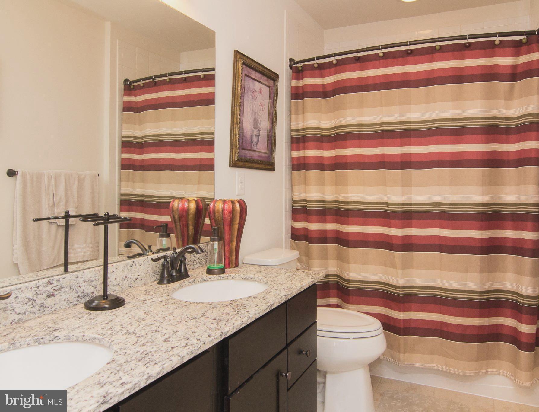 10422 Windlass Run Road Baltimore, MD 21220 - Photo 23 of 30 a bathroom with a granite countertop sink and a mirror