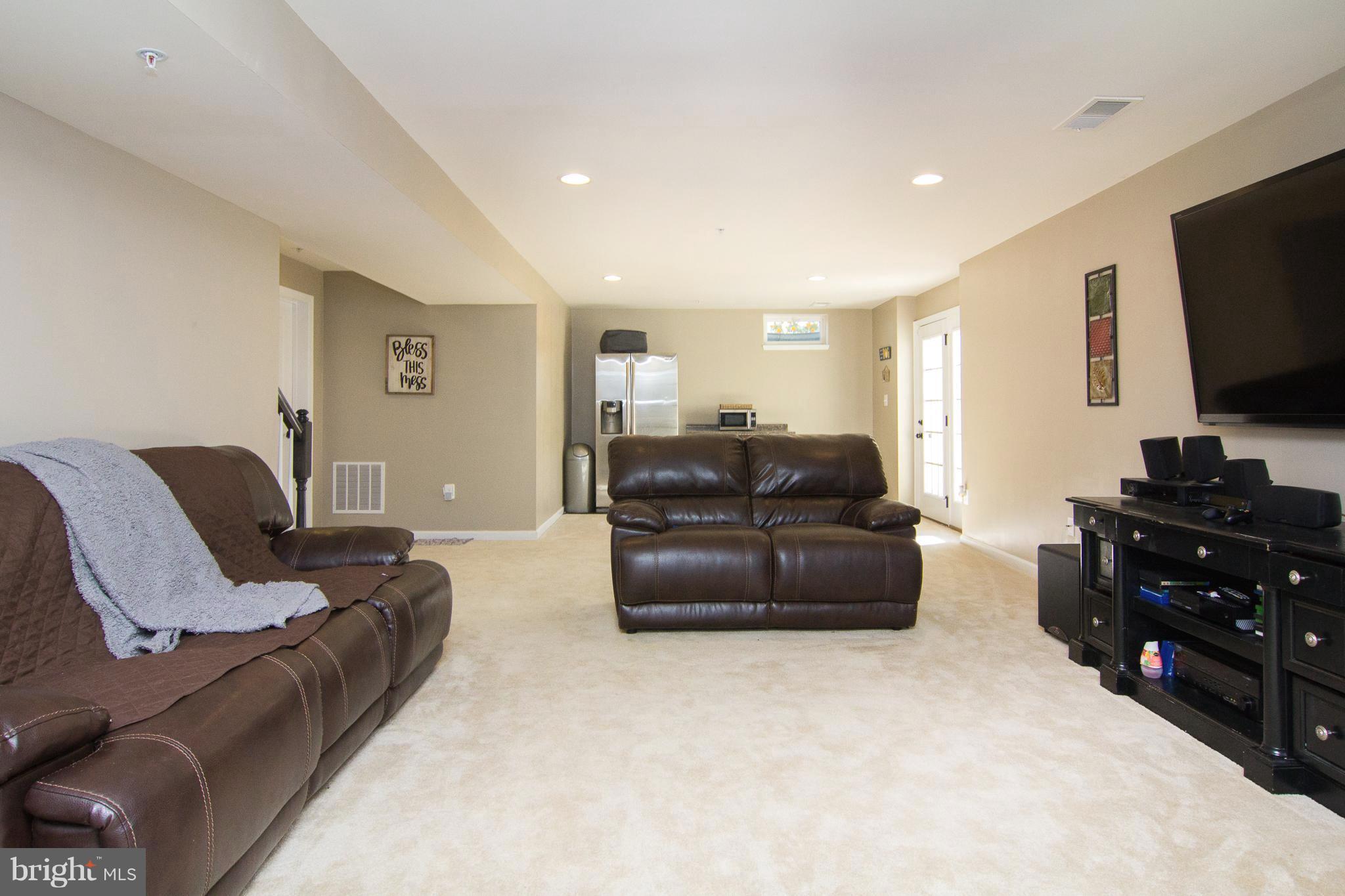 10422 Windlass Run Road Baltimore, MD 21220 - Photo 24 of 30 a living room with furniture and a flat screen tv