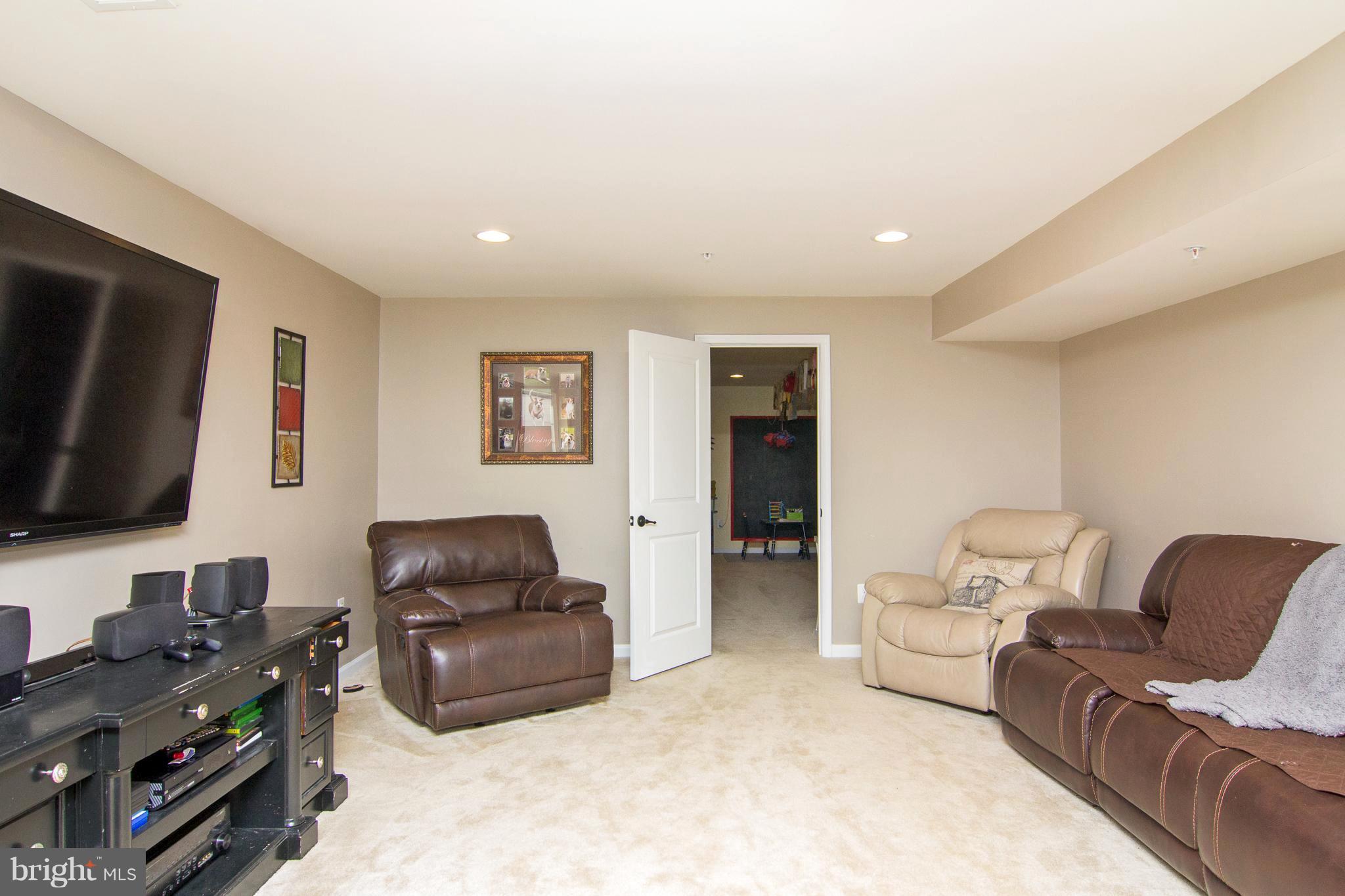 10422 Windlass Run Road Baltimore, MD 21220 - Photo 25 of 30 a living room with furniture a flat screen tv and a window
