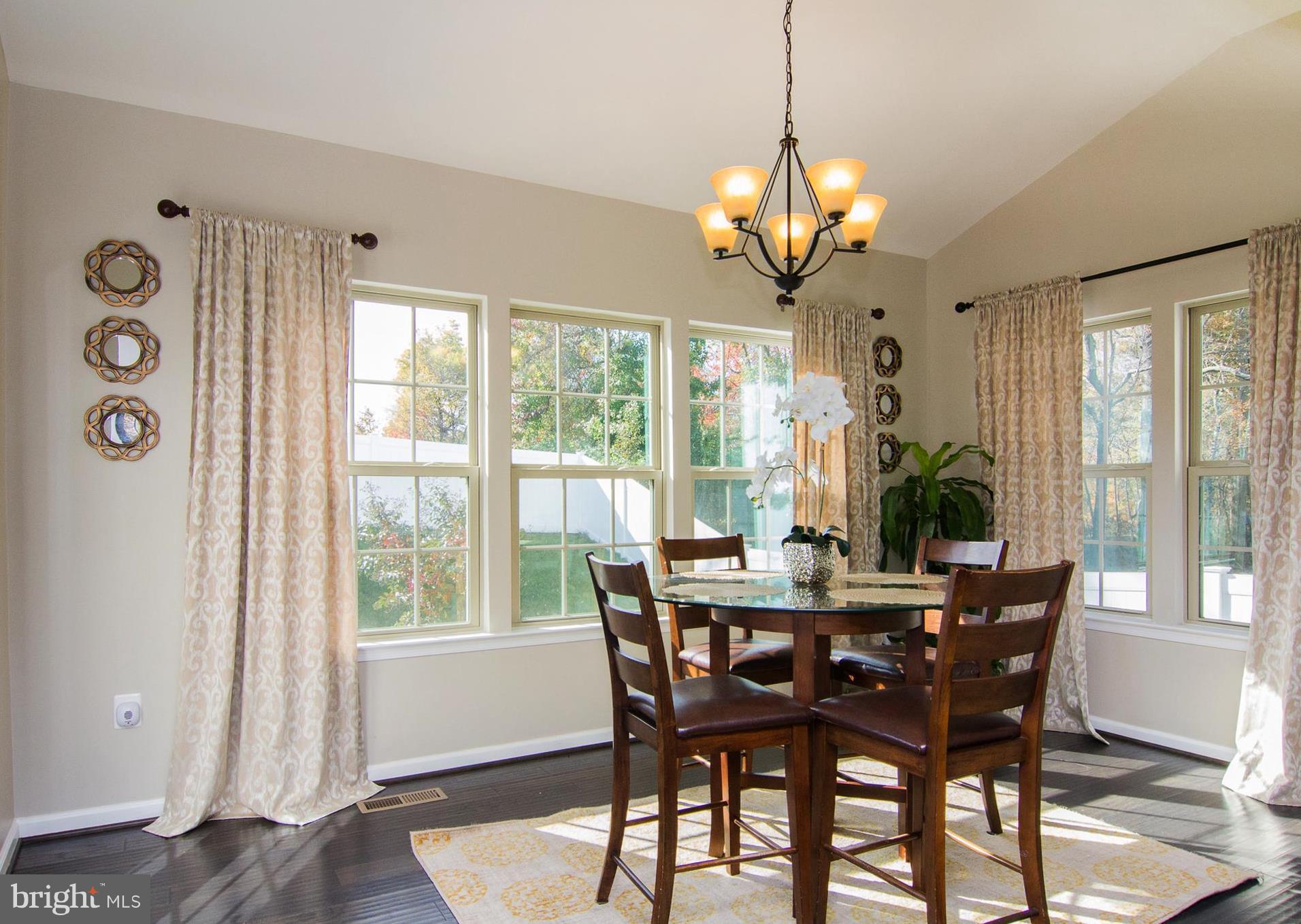 10422 Windlass Run Road Baltimore, MD 21220 - Photo 6 of 30 a dining room with furniture a chandelier and wooden floor