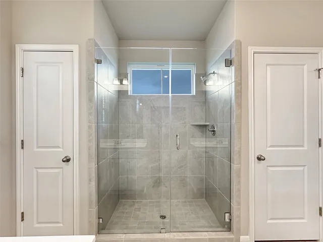 a bathroom with a glass shower door