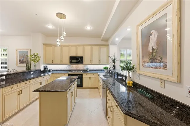 a kitchen with stainless steel appliances granite countertop a stove and a sink