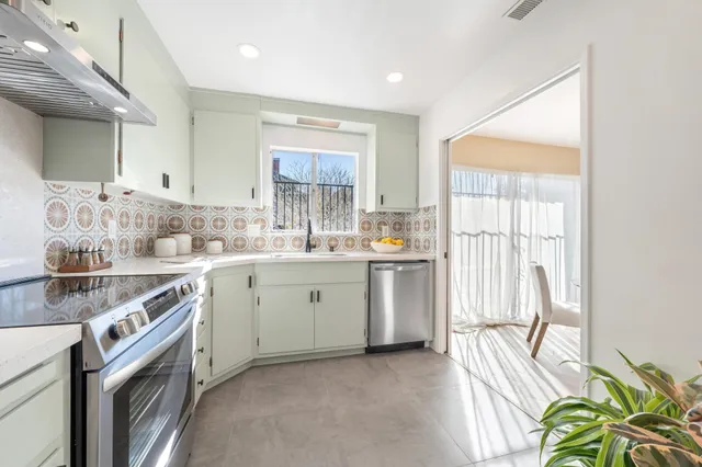 a kitchen with a sink stove and cabinets