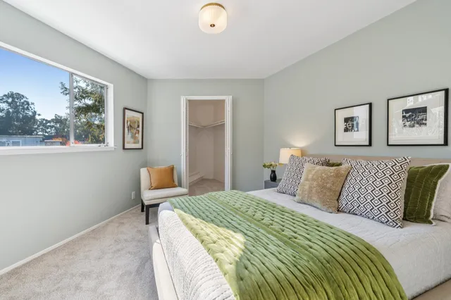 a bathroom with a bathtub shower sink mirror and toilet