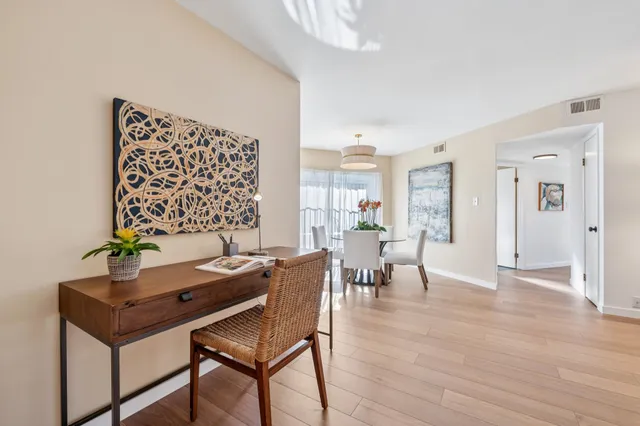 a view of a dining room with furniture and wooden floor