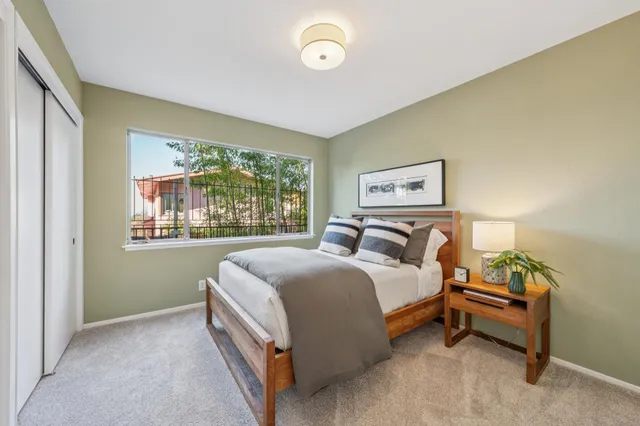 a bedroom with a bed and glass window