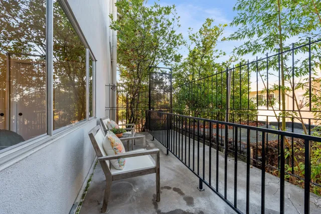 a balcony with furniture and a garden