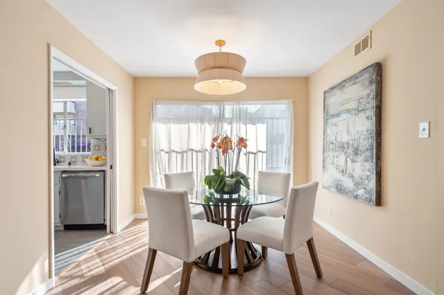 a view of a dining room with furniture window and wooden floor
