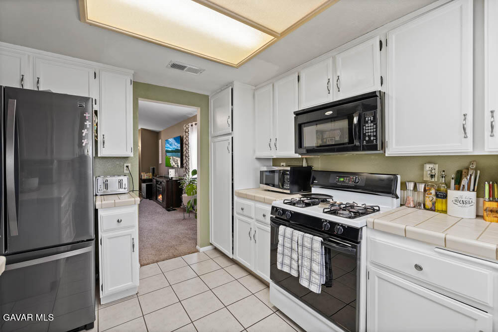 2425 Williams Court Rosamond, CA 93560 - Photo 15 of 35 a kitchen with stainless steel appliances granite countertop a refrigerator stove and sink
