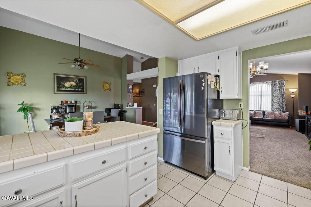 2425 Williams Court Rosamond, CA 93560 - Photo 16 of 35 a kitchen with refrigerator and cabinets