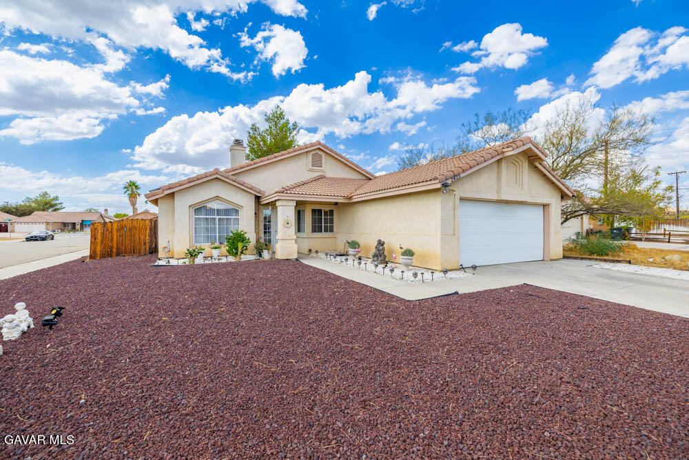 2425 Williams Court Rosamond, CA 93560 - Photo 2 of 35 a view of a house with a yard and garage