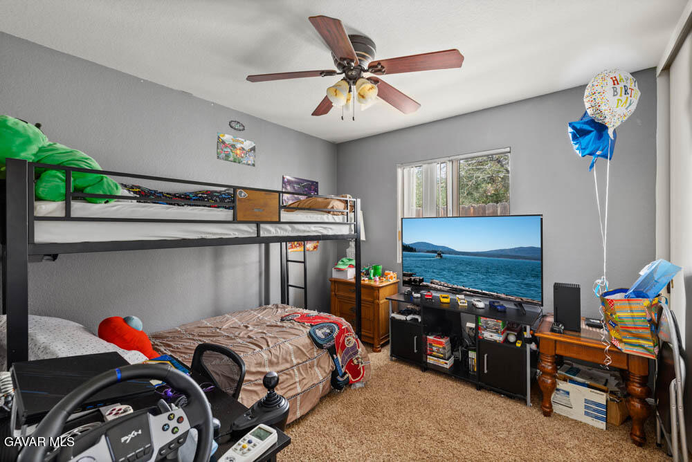 2425 Williams Court Rosamond, CA 93560 - Photo 23 of 35 a bedroom with a bed and a flat screen tv