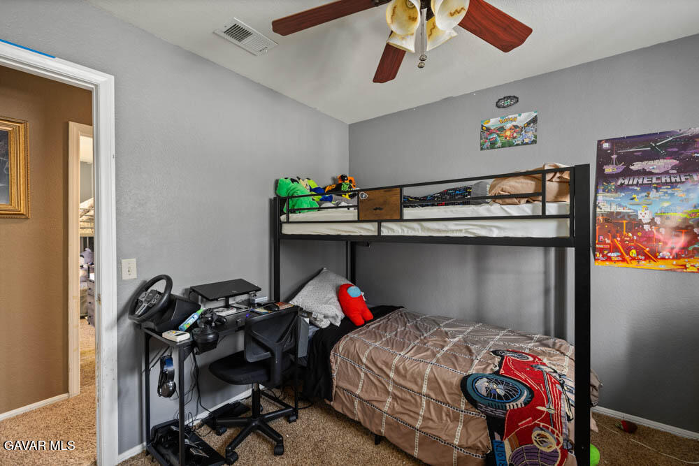 2425 Williams Court Rosamond, CA 93560 - Photo 24 of 35 a bedroom with a bed and wooden floor