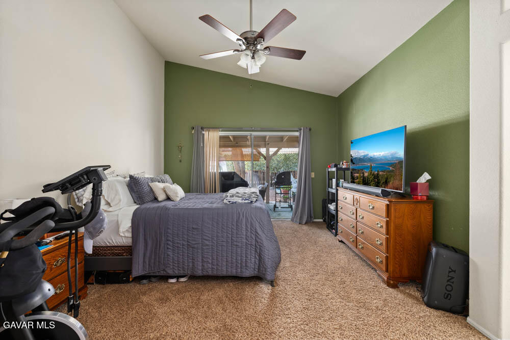 2425 Williams Court Rosamond, CA 93560 - Photo 25 of 35 a living room with a bed furniture and a flat screen tv