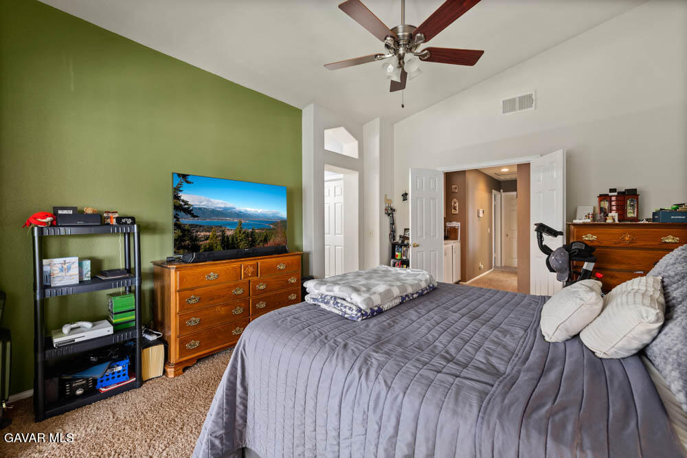 2425 Williams Court Rosamond, CA 93560 - Photo 26 of 35 a bedroom with a bed and a flat tv screen on dresser